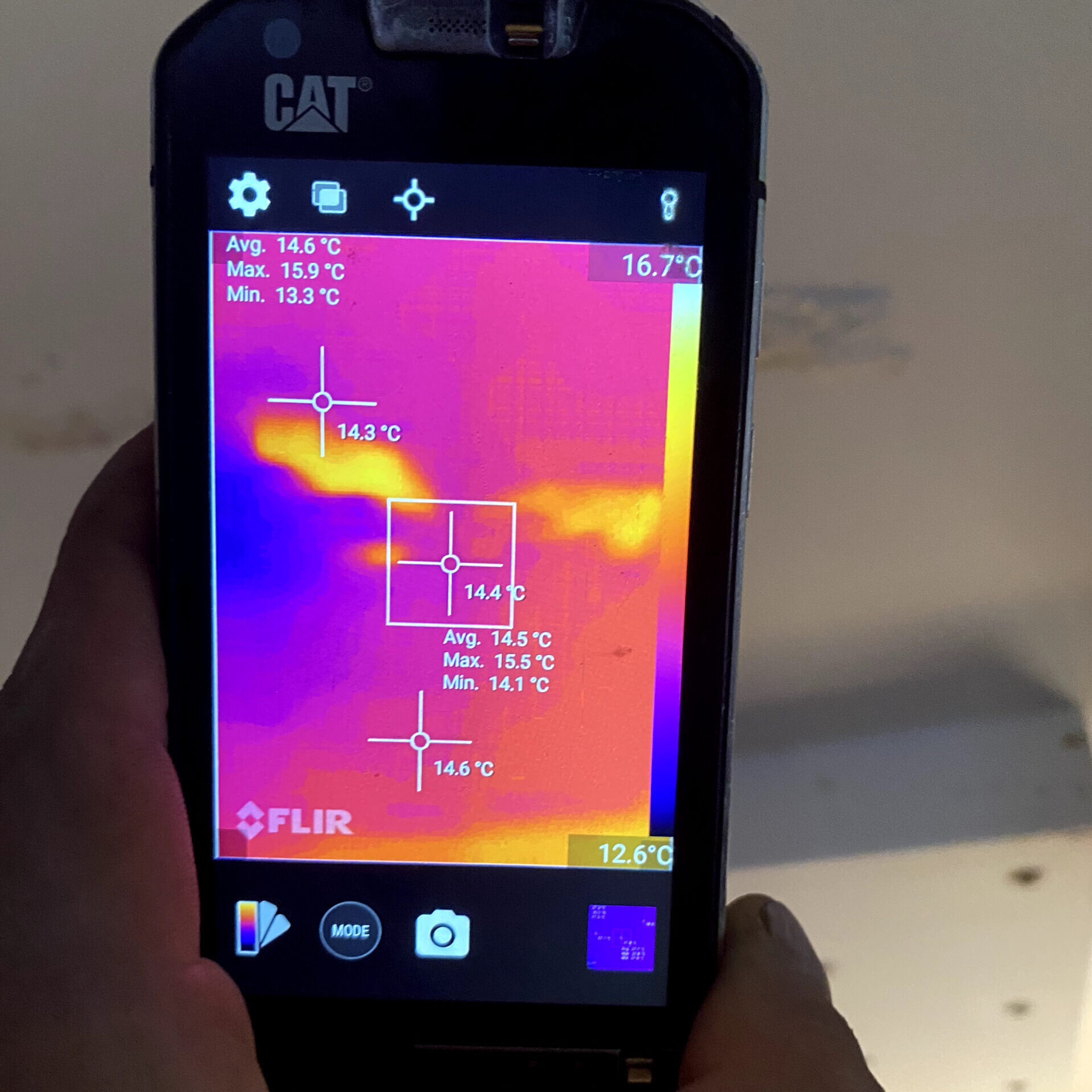 A thermal camera being used to spect temperature variations of moisture present on a ceiling